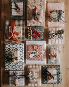 many wrapped presents are laid out on the table