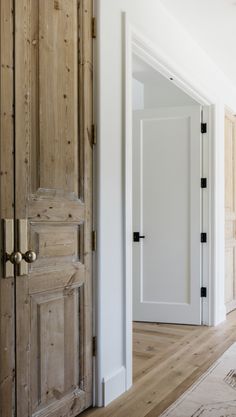 an empty room with wooden doors and white walls