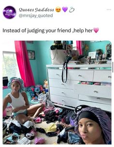 two women sitting on the floor in front of a dresser with clothes all over it