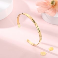 Inspirational Bracelet * Gold Engraved Bangle * Quote Bracelets Silver * Engraved Bracelet For Women Cuff Bracelet * Encouragement Bracelet Introducing our newest accessory - the Inspirational Engraved Bracelet! This beautiful bangle is engraved with a positive, uplifting quote to remind you of your inner strength and resilience. Whether you're looking for a daily dose of motivation or a special gift for a loved one, this bracelet is sure to inspire. The delicate, gold-plated bracelet is adjustable to fit any wrist size, and the simple design makes it perfect for everyday wear. Dress it up or down - it's perfect for any occasion! Let the Inspirational Engraved Bracelet serve as a reminder that you are capable of anything. M A T E R I A L ■ Made from 316L surgical Stainless Steel ■ Designed Adjustable Engraved Stainless Steel Cuff Bracelet, Adjustable Engraved Stainless Steel Bangle, Stainless Steel Friendship Bangle, Personalized Metal Bangle Cuff Bracelet, Personalized Metal Cuff Bangle Bracelet, Adjustable Engraved Bangle Bracelet, Adjustable Personalized Metal Cuff Bracelet, Personalized Adjustable Metal Cuff Bracelet, Engraved Metal Bangle For Gift