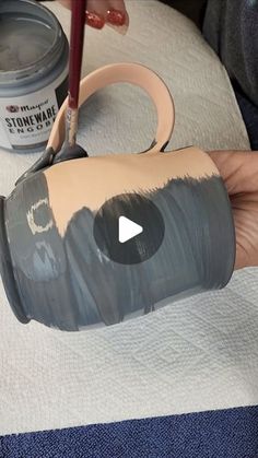 someone is painting the inside of a cup