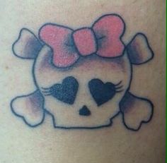 a skull with a bow on its head and hearts in the shape of a heart