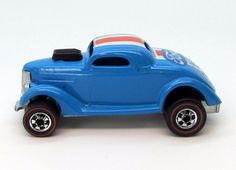 a blue toy car with red, white and blue stripes on it's side