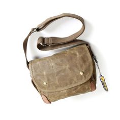 Small-Waxed-Canvas-Crossbody-Bag-tan Khaki Shoulder Bag For Everyday Use, Outdoor Shoulder Bag In Coated Canvas With Waxed Finish, Durable Khaki Shoulder Bag For Everyday Use, Classic Outdoor Shoulder Bag With Waxed Finish, Classic Waxed Canvas Shoulder Bag For Outdoor, Waxed Finish Canvas Shoulder Bag For Outdoors, Vintage Outdoor Shoulder Bag With Pockets, Vintage Shoulder Bag With Pockets For Outdoor, Classic Outdoor Waxed Canvas Shoulder Bag