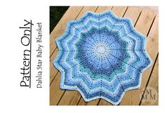 a blue crocheted doily is sitting on a wooden table