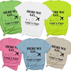 four different colored shirts with the words here we go, girls trip and an airplane