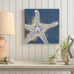 a starfish painting on a wall above a table