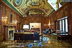 an ornately decorated living room with wood paneled walls and ceiling, along with marble flooring