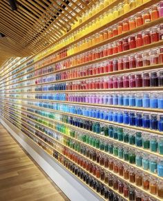 the wall is filled with many different colored liquids