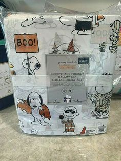 the package is wrapped in plastic and has pictures of dogs on it, including a sign that says boo