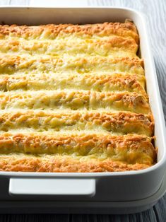 a casserole dish filled with cheese and meat