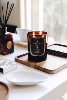 a candle sitting on top of a wooden tray