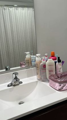 the bathroom sink is full of personal care products