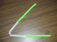 a green and white toothbrush sitting on top of a wooden table