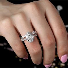 a woman's hand with a diamond ring on it