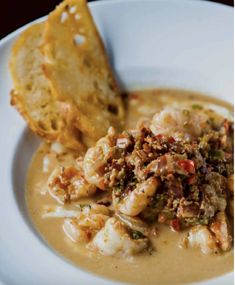 a white plate topped with soup and bread