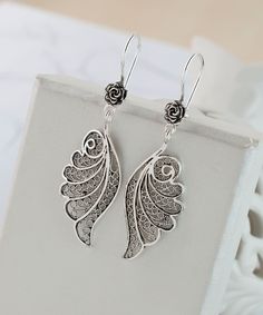 Angel Wing Dangle Earrings 925 Sterling Silver Wing Drop Earrings Artisan Handcrafted Filigree Floral Earrings Women Handmade Jewelry, Best Friend Gift, Bridesmaid Gift, vintage earrings, sparkly earrings Material: 925 Sterling Silver (NICKEL FREE) Length, Drop and Width: 5.5cm X 3.5cm X 1.6cm // 2.15 Inches X 0.6 Inches UPS - FREE, FAST AND TRACKABLE SHIPPING FOR ALL EU COUNTRIES AND USA. These earrings are so stunning and dainty. Perfect for everyday wear. They have a gorgeous small flower on the top of the earring and angel wing that hangs dainty. These earrings are made from our finest silver so they are durable for your everyday wear. COMES WİTH VELVET POUCH AND LUXURY GİFT BOX. Makes a great gift: Beautiful jewelry to give for every occasion. The perfect present  for mom , sister, da Filigree Jewelry Design, Unique Sterling Silver Earrings With Intricate Design, Unique Sterling Silver Filigree Earrings, Silver Earrings With Intricate Design As Gift, Silver Earrings With Intricate Design For Gift, Ornate Silver Earrings With Ear Wire, Ornate Sterling Silver Earrings For Gift, Ornate Sterling Silver Earrings For Pierced Ears, Sterling Silver Filigree Earrings As A Gift