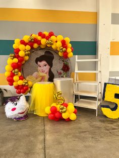 there are balloons and decorations on the floor in front of a wall with a photo