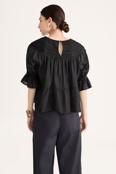 Our classic SOL blouse, re-imagined for Collection 14. Featuring rows of cross-shaped and herringbone-pattern engineered eyelets at the yoke. Crochet trim delineates the tiers in the body, and the sleeves have an elasticated, ruffled cuff. The SOL has a voluminous silhouette and is best worn loose over form-fitting pants like the SARGENT or LEON pants. Crafted in smooth 100% Pima cotton lawn that has a slight sheen. Voluminous fit. True to size in the shoulders and yoke. Chic Eyelet Blouse For Daywear, Elegant Eyelet Tops For Daywear, Fall Workwear Top With Broderie Anglaise, Broderie Anglaise Tops For Work, Fitting Pants, Eyelet Top, Crochet Trim, Herringbone Pattern, Pima Cotton