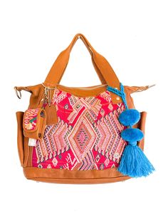 a handbag with a tasselled handle and colorful pattern on the front pocket