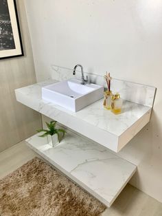 a white sink sitting on top of a bathroom counter next to a rug and mirror