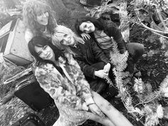 the runaways posing for a black and white photo in front of a christmas tree