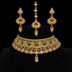 India Gold Choker Necklace is a stunning piece of Jadau jewelry inspired by antique South Indian temple designs. This statement choker, ideal for Pakistani bridal wear, showcases intricate craftsmanship and traditional elegance. Perfect for Bollywood weddings, it makes a memorable and luxurious gift for special occasions. *𝐏𝐑𝐎𝐃𝐔𝐂𝐓 𝐃𝐄𝐓𝐀𝐈𝐋* * Material: Brass * Plating: Gold Plated *𝐃𝐈𝐌𝐄𝐍𝐒𝐈𝐎𝐍𝐒* * Necklace:-  Weight: 72 gm, Neck Size :- 4.2 Inches, Width: 2.05 Inches. * Earrin Temple Jewelry Meenakari Necklaces For Marriage, Bollywood Kundan Necklace For Marriage With Intricate Design, Temple Jewelry Meenakari Necklace For Marriage, Gold Meenakari Bridal Necklace For Marriage, Gold Meenakari Bridal Necklace For Wedding, Intricate Design Necklace For Marriage And Diwali, Traditional Gold Tikka For Marriage, Intricate Design Necklace For Marriage During Diwali, Intricate Diwali Necklace For Marriage