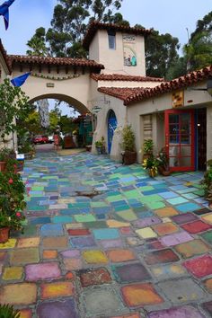 an outdoor courtyard with colorful tiles on the ground