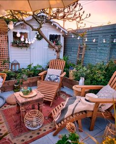 an outdoor patio with chairs, tables and potted plants