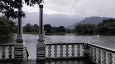 a view of a river with boats in the water and mountains in the back ground