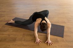 a woman is doing yoga on a mat