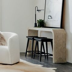 a living room with two stools and a table