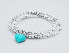 925 Sterling Silver Stretch Turquoise Puff Heart Charm Bracelet 4mm Sterling Silver Beads 15mm Sterling Silver Turquoise Enamel Puff Heart Charm Stack of 2 includes: one Purple Turquoise Heart Charm Bracelet one 3mm Plain Bracelet Stack of 3 includes: one Purple Turquoise Heart Charm Bracelet one 3mm Plain Bracelet one 4mm Plain Bracelet This bracelet is perfect for stacking or just wear on its own. Turquoise Heart Beads Bracelet, Turquoise Bracelet With Heart Charm For Gifts, Turquoise Bracelet With Heart Charm As Gift, Turquoise Bracelets With Heart Charm As Gift, Turquoise Heart Bracelet As A Gift, Turquoise Heart Beads Bracelet As Gift, Turquoise Heart Beads Bracelet For Gift, Turquoise Heart Charm Bracelet Gift, Turquoise Heart Beads Bracelet Gift