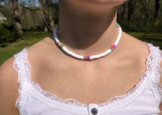 -Hey everyone! Please enjoy these handmade beaded choker necklaces! -They are made out of elastic cord and can stretch easily. -Light blue, white, light pink, and lavender chokers are pictured however you can choose from a variety of colors! -These chokers are the perfect gift for friends, family, or loved ones! Handmade White Heishi Beads Choker, White Choker With Colorful Beads For Vacation, White Beaded Choker For Vacation, White Round Beads Choker For Beach, Handmade White Choker For Vacation, White Adjustable Casual Choker, White Beaded Necklaces With Letter Beads, White Casual Choker For Vacation, White Casual Adjustable Choker