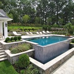 an outdoor swimming pool with steps leading up to it