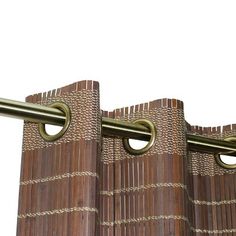 two metal bars are attached to the side of a bamboo curtain