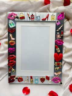 a mirror with lots of different items on it and red petals around the edges, as well as hearts