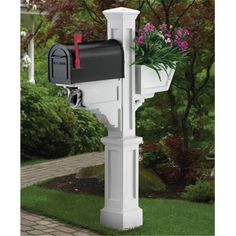 a white mailbox with flowers in it