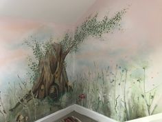 a room with a tree trunk painted on the wall next to a rug and carpet