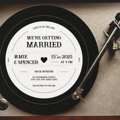 a record player with the words we're getting married on it next to a pair of scissors