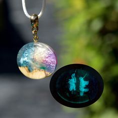 a close up of a glass ball on a string with a pendant attached to it