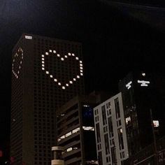 a large building with the word love written on it in front of other tall buildings