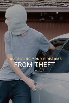 a man in a gray shirt is opening the hood of a car with his hands