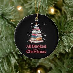 a christmas tree ornament with books on it