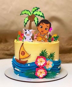 a cake decorated with cartoon characters and flowers