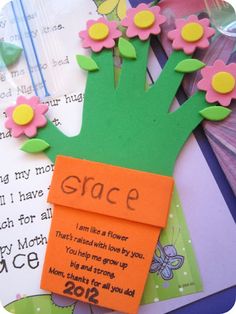 an orange piece of paper with flowers on it and the words grace written on it