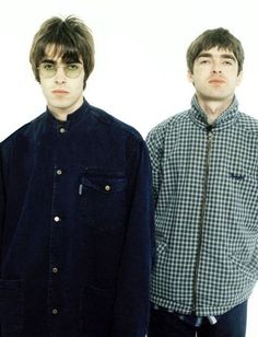 two young men standing next to each other in front of a white background wearing glasses