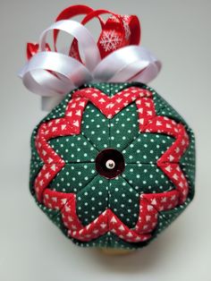 an ornament with red and green designs on it