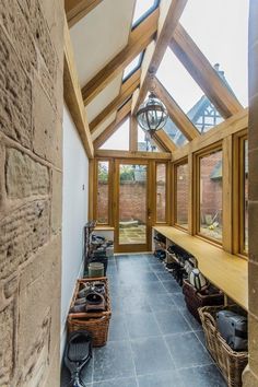 the inside of a building with lots of windows and wooden benches in front of it