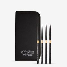 three black and gold brushes in a case with the words, she's brush monaco